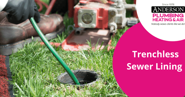 Plumber installing trenchless sewer lining in grassy yard